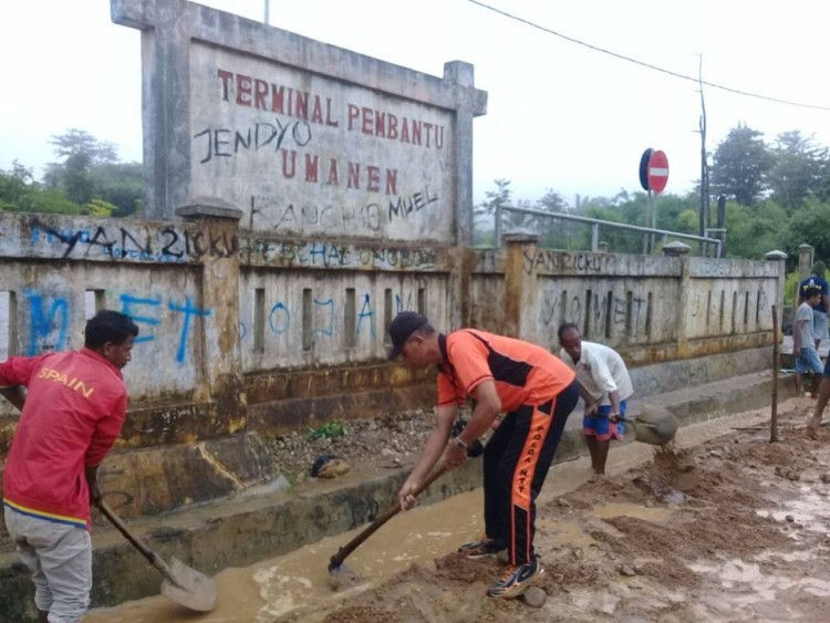 Bergelut dengan Lumpur, Bhabinkamtibmas Umanen Polres Bersihkan Saluran Air di Terminal Sesekoe